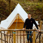 Matthew Kendall in front of the Bell Tent at The Eden-field Project, Edenfield
